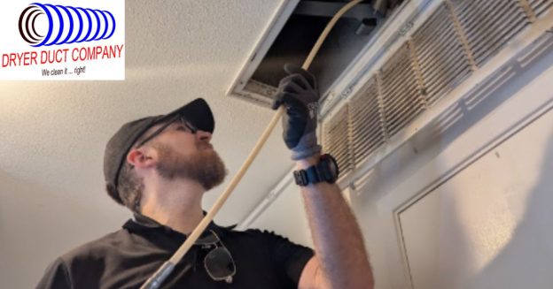 Technician inspecting a residential dryer vent installation to identify improper vent connections and airflow issues by Dryer Duct Company.